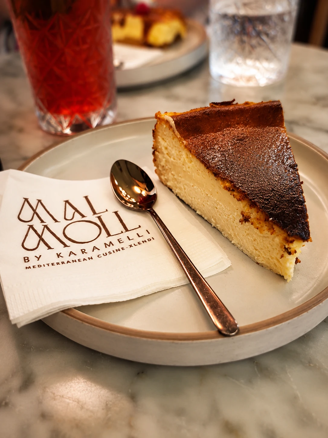 Baked cheesecake slice served at Karamelli